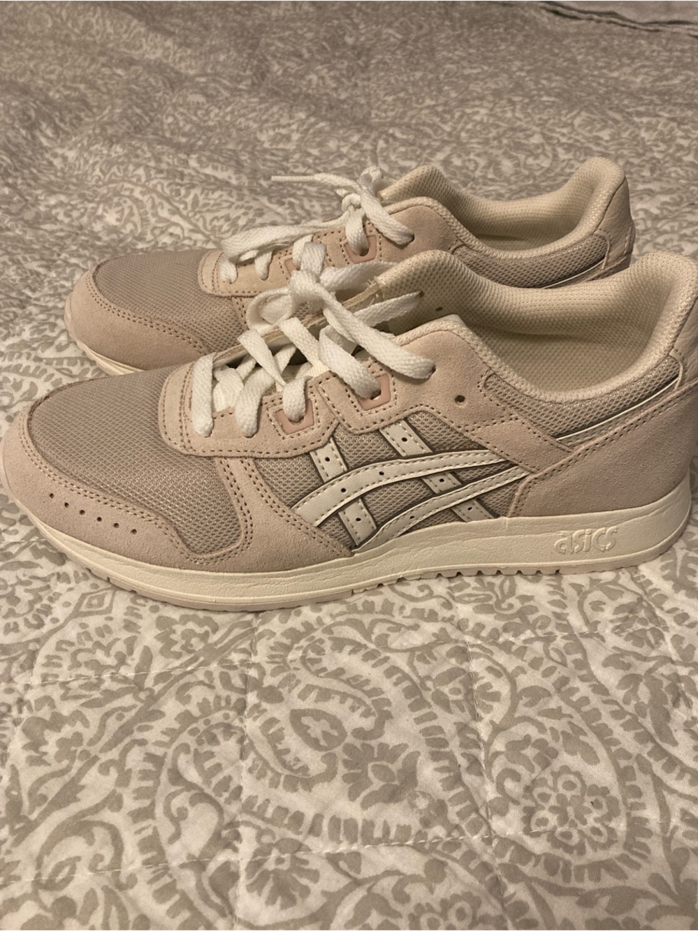 ASICS women’s Pale Pink Lace-Up Sneakers with White Stripes